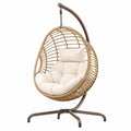 Fauteuil suspendu en rotin beige Tornavik avec support en métal, style bohème, dimensions 120x105x195 cm.